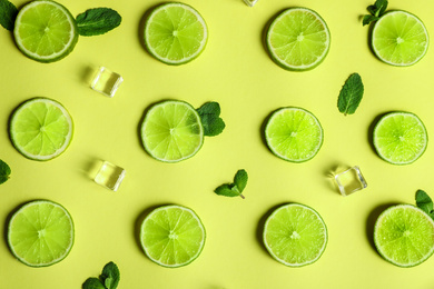 Photo of Flat lay composition with fresh juicy limes on yellow background