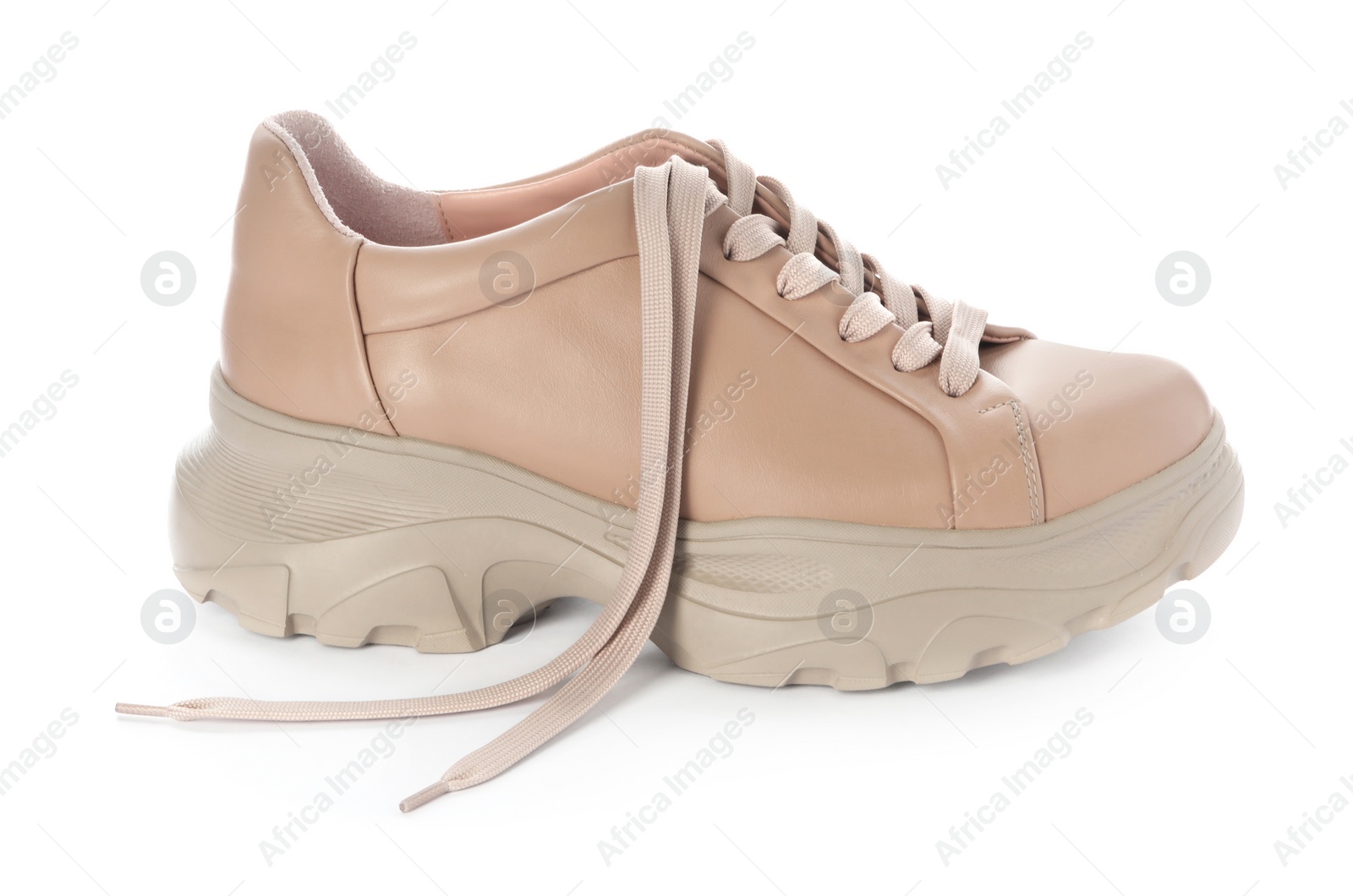 Photo of Stylish beige sneaker with shoelaces on white background