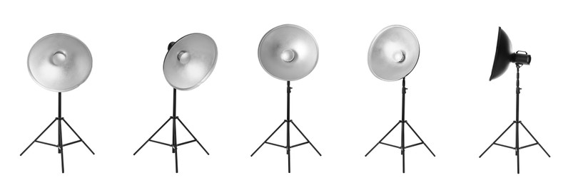 Image of Set with studio flash lights with reflectors on tripods against white background. Banner design