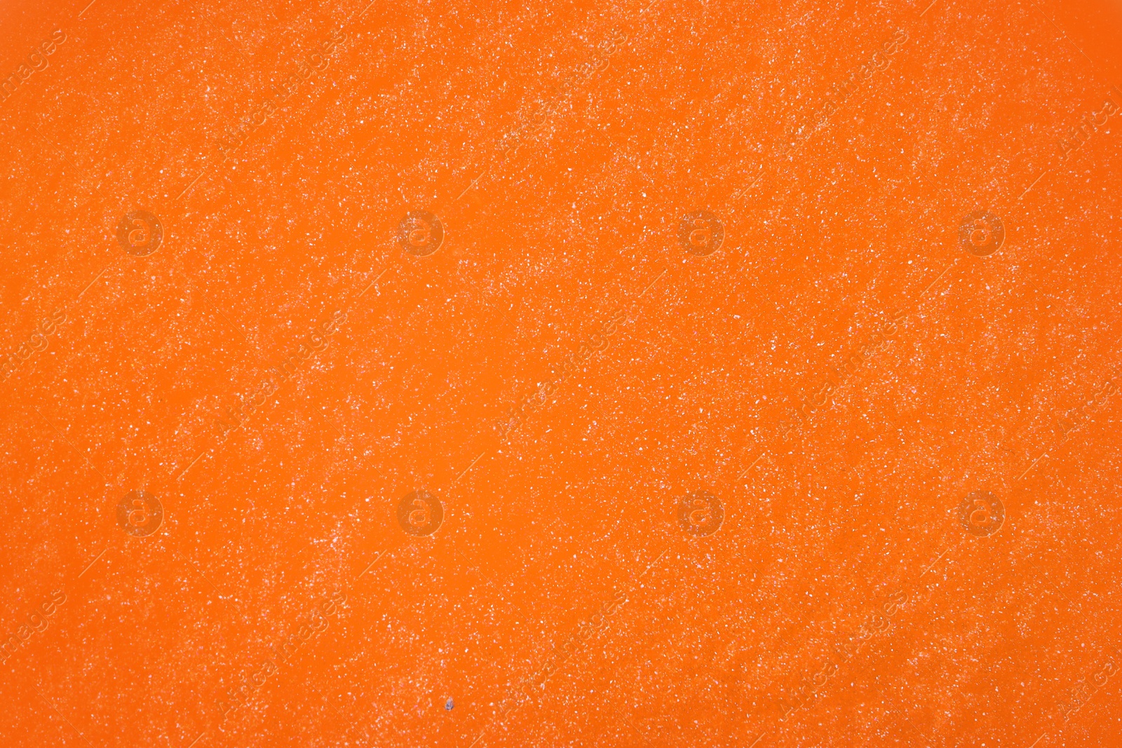 Image of Closeup view of orange slime as background. Antistress toy