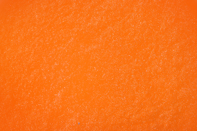 Image of Closeup view of orange slime as background. Antistress toy