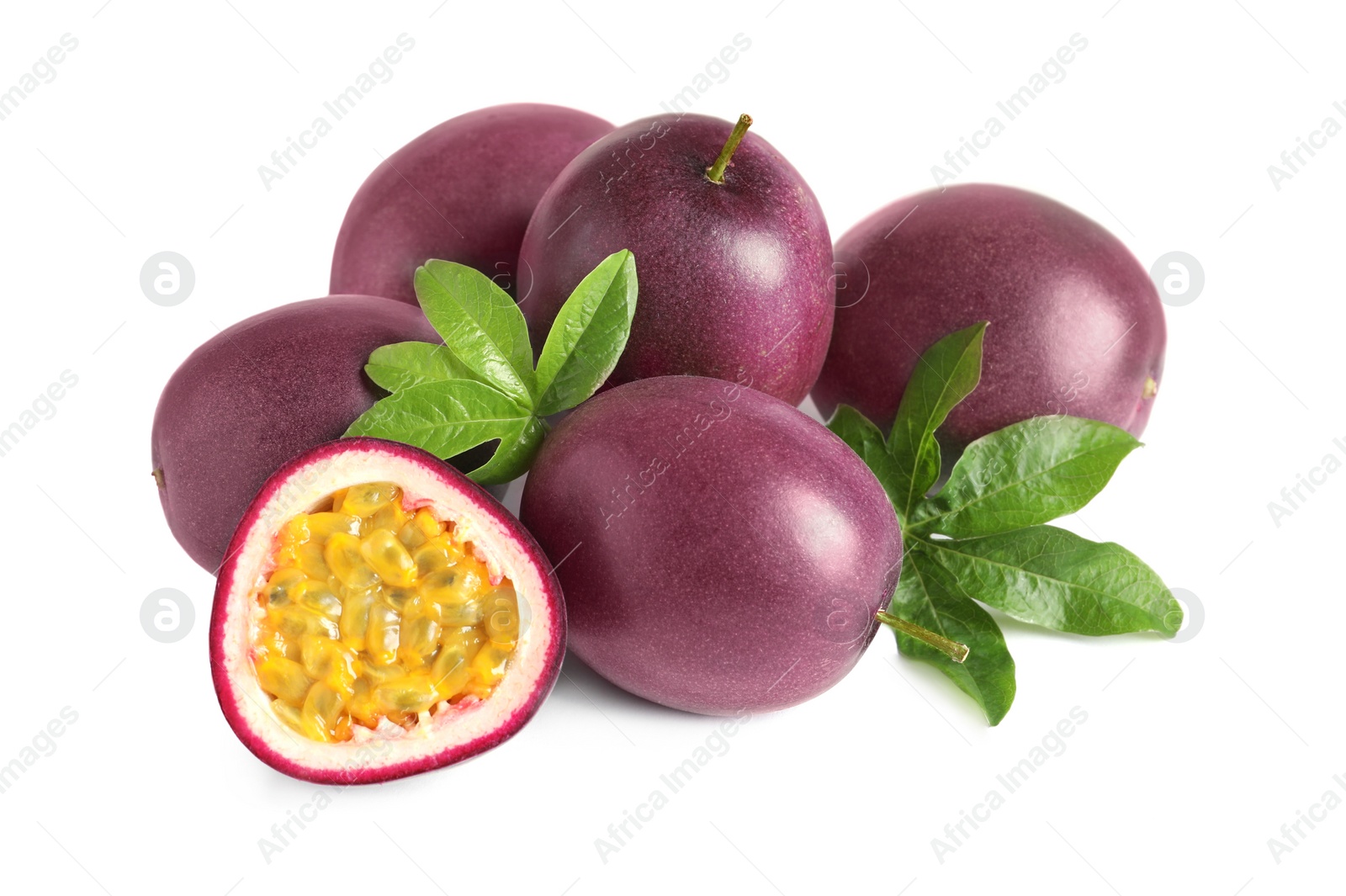 Photo of Cut and whole passion fruits with leaves on white background