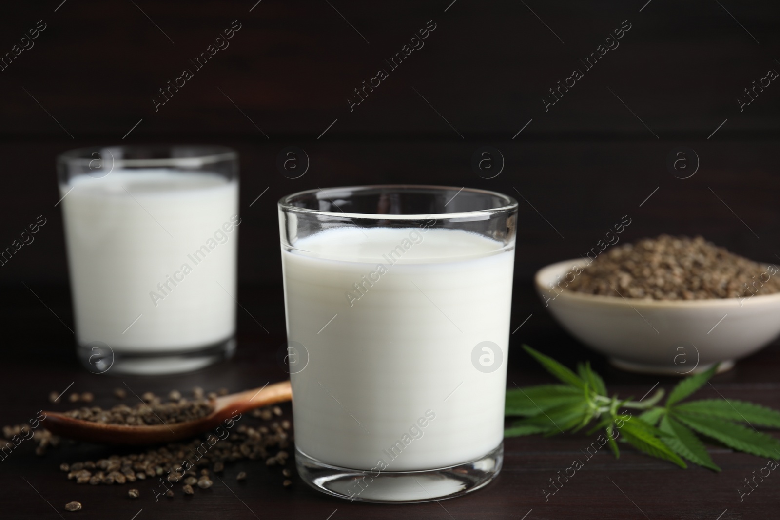 Photo of Glass of fresh hemp milk on wooden table