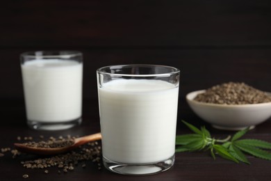 Photo of Glass of fresh hemp milk on wooden table