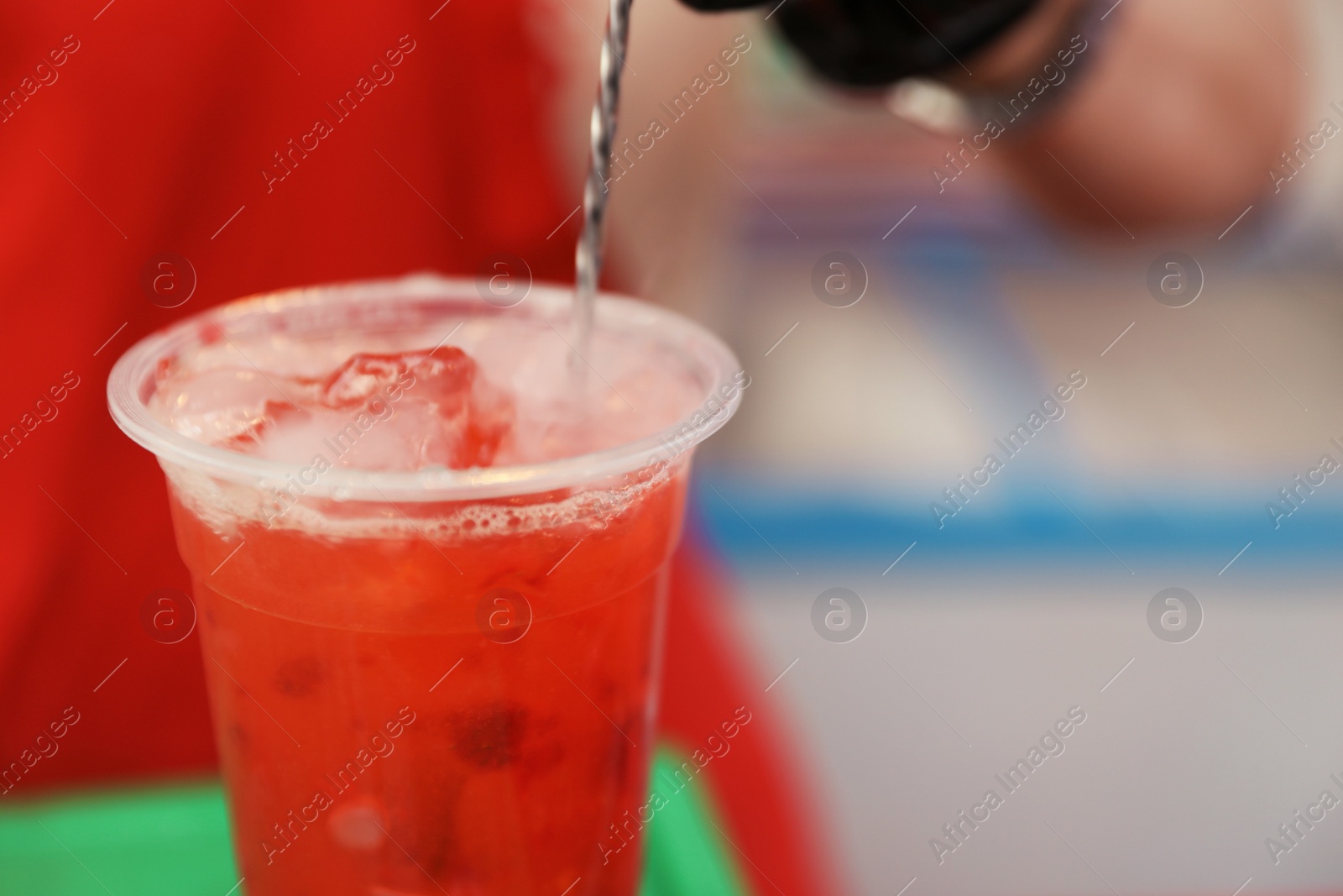 Photo of Preparing delicious refreshing drink against blurred background, closeup