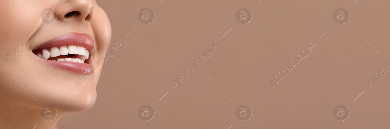 Image of Woman with clean teeth smiling on brown background, closeup. Banner design with space for text