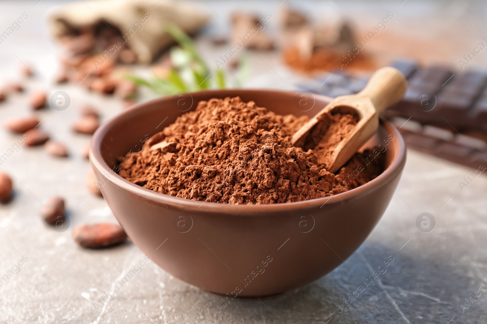 Photo of Bowl with cocoa powder on table