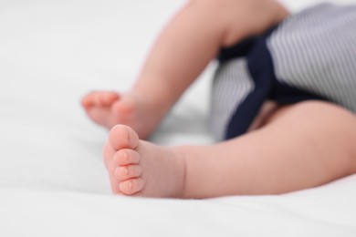 Photo of Newborn baby lying on white blanket, closeup