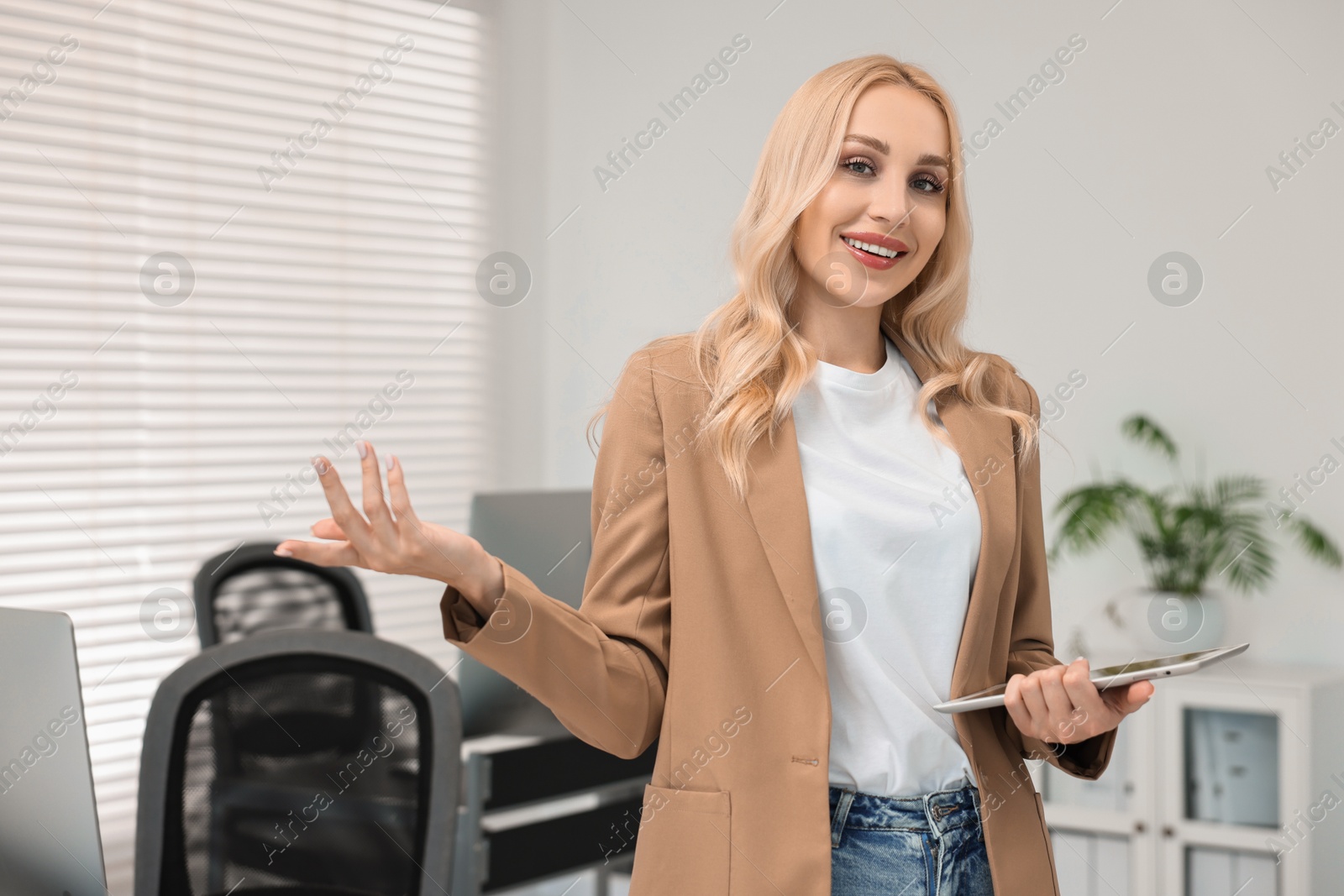 Photo of Portrait of happy secretary with tablet in office