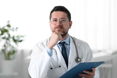 Portrait of doctor with clipboard in clinic