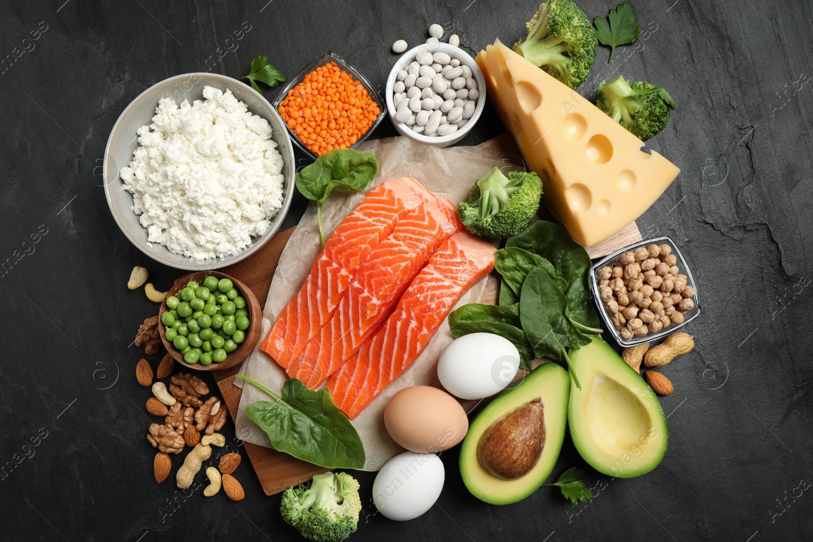 Photo of Products rich in protein on black table, flat lay