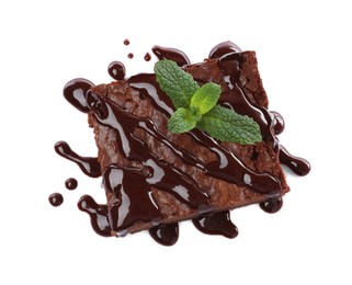 Delicious chocolate brownie with sweet syrup and fresh mint on white background, top view