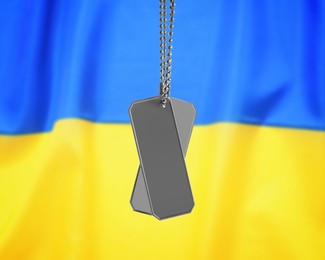 Image of Military ID tags and Ukrainian flag on background