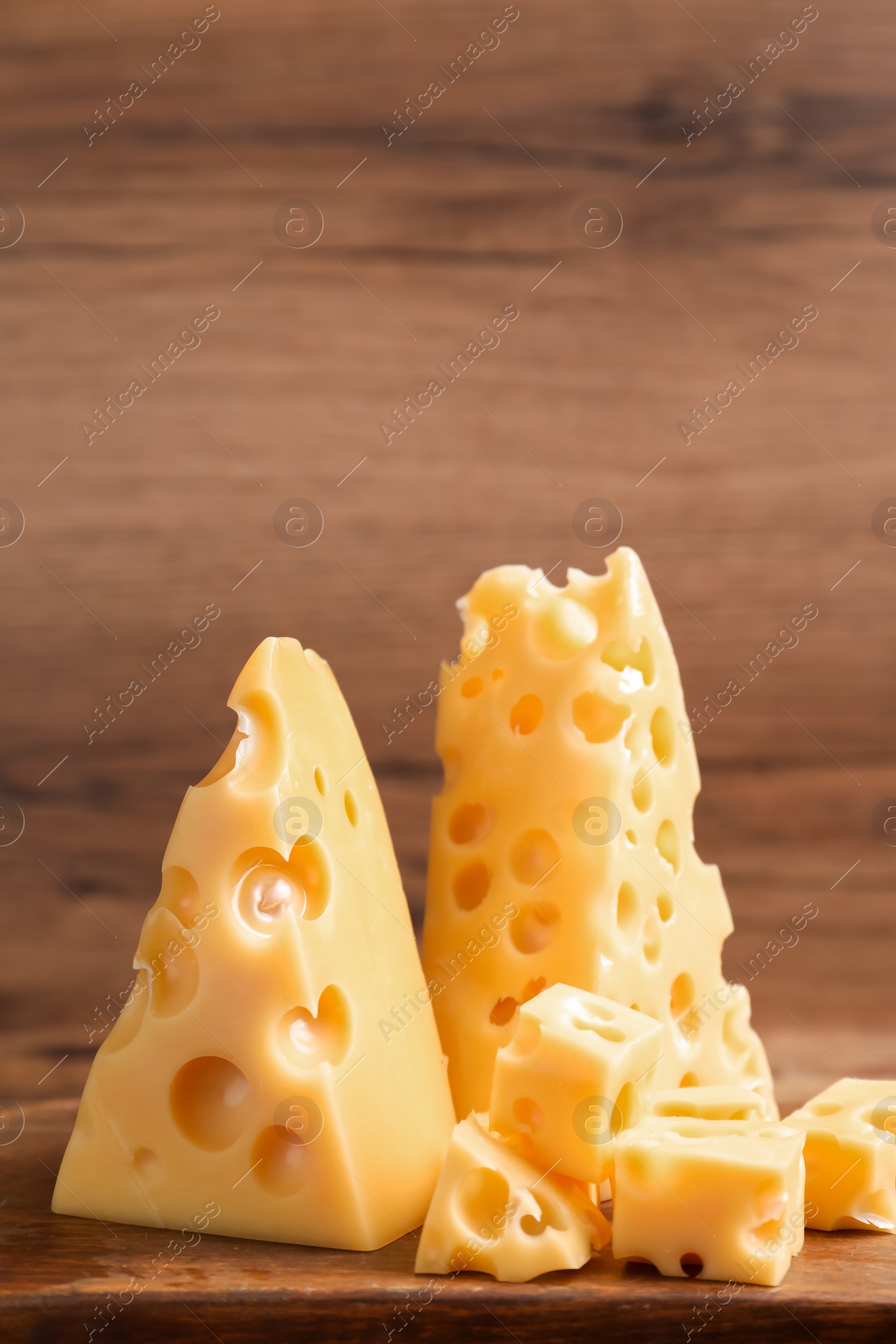 Photo of Tasty fresh cheese on wooden table, closeup