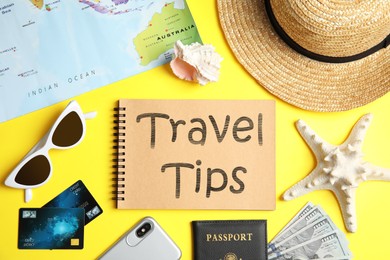 Image of Flat lay composition with tourist items and notebook on yellow background. Travel Tips