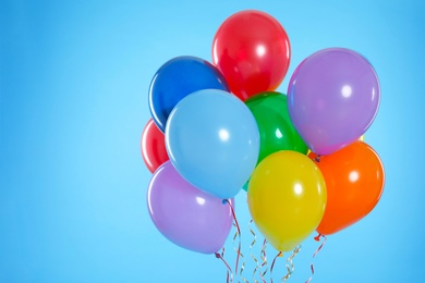 Bunch of bright balloons on color background. Space for text