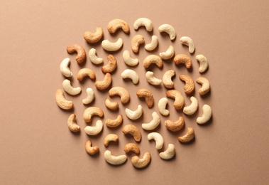 Tasty cashew nuts on color background, flat lay