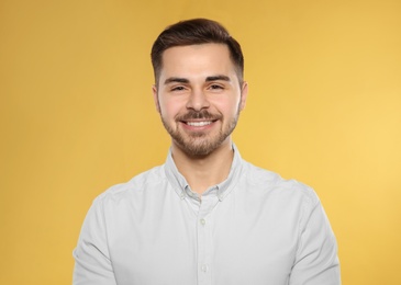Photo of Portrait of handsome young man on color background