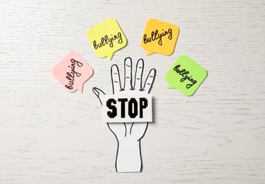 Photo of Composition with text Stop Bullying on white wooden table, flat lay