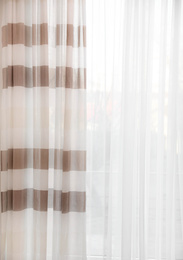 Photo of Window with elegant curtains in empty room