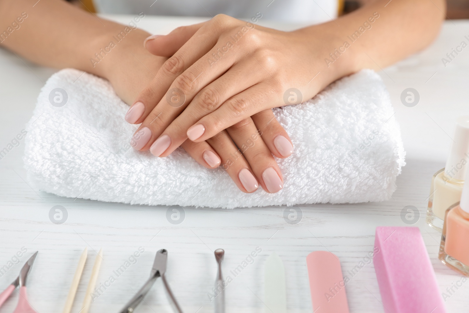 Photo of Woman waiting for manicure and tools on table, closeup. Spa treatment