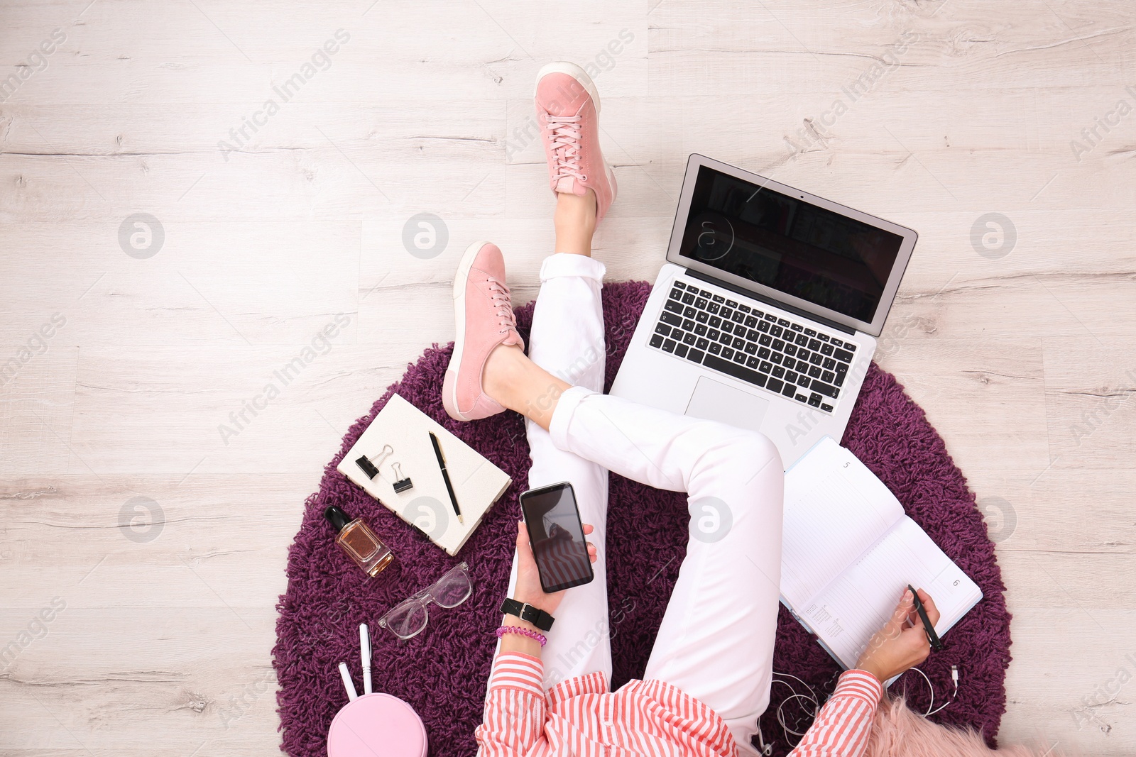 Photo of Fashion blogger with laptop sitting on floor, top view