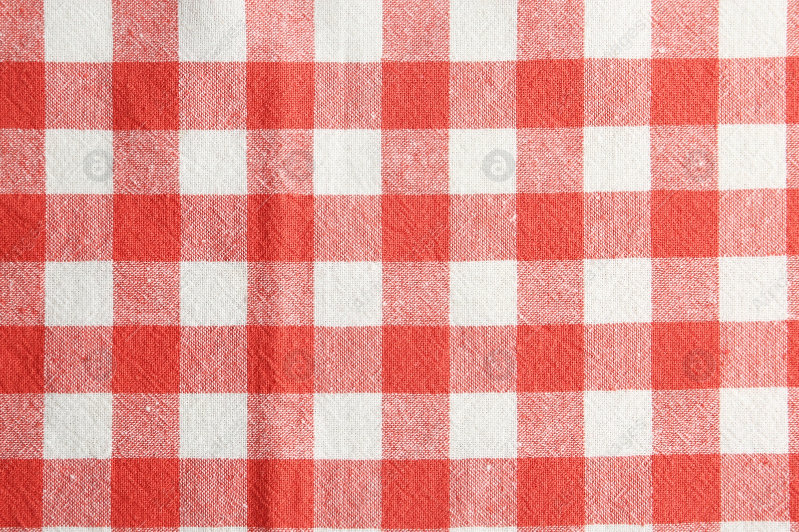 Photo of Texture of red checkered fabric as background, closeup