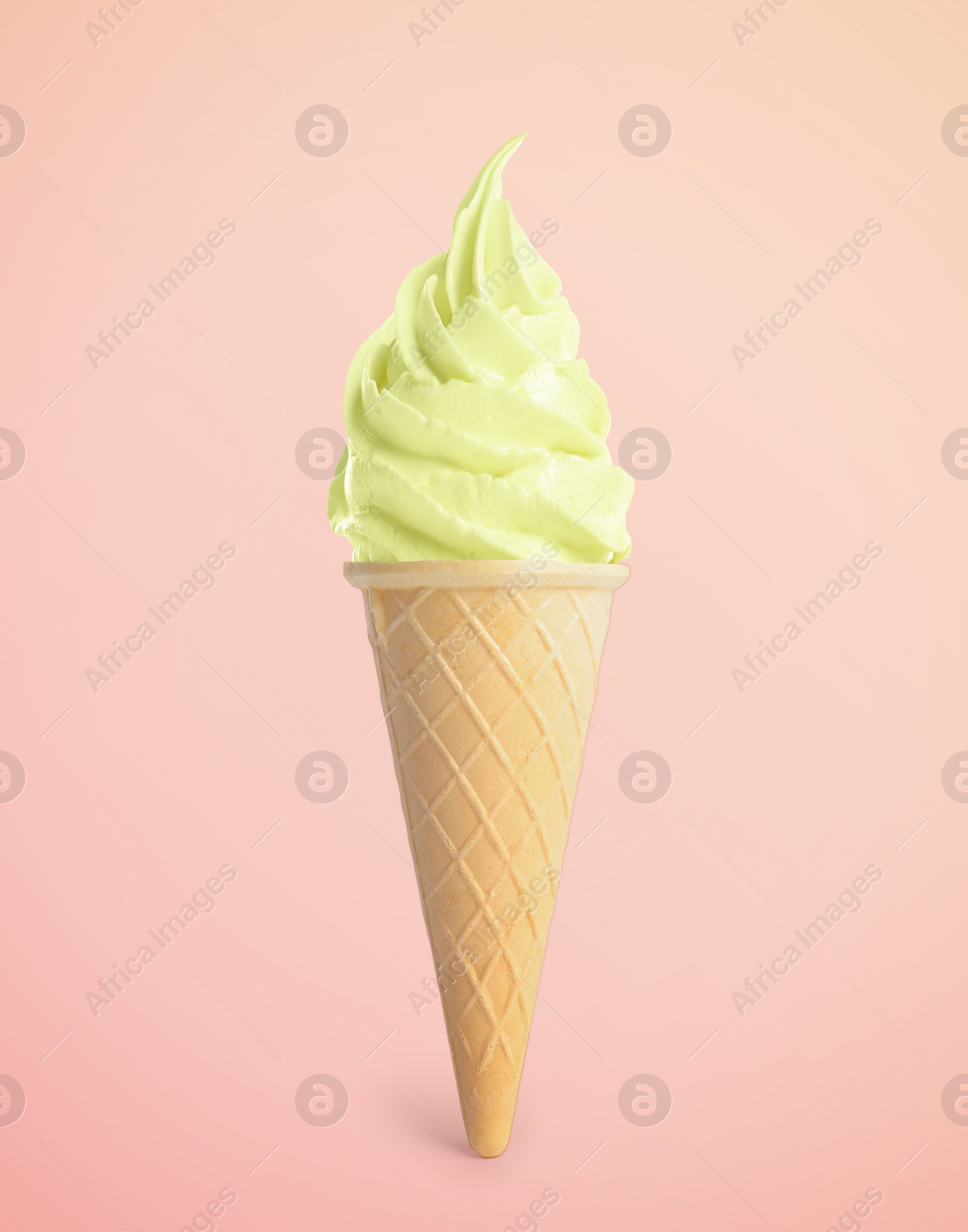 Image of Tasty ice cream in waffle cone on pastel pink background. Soft serve