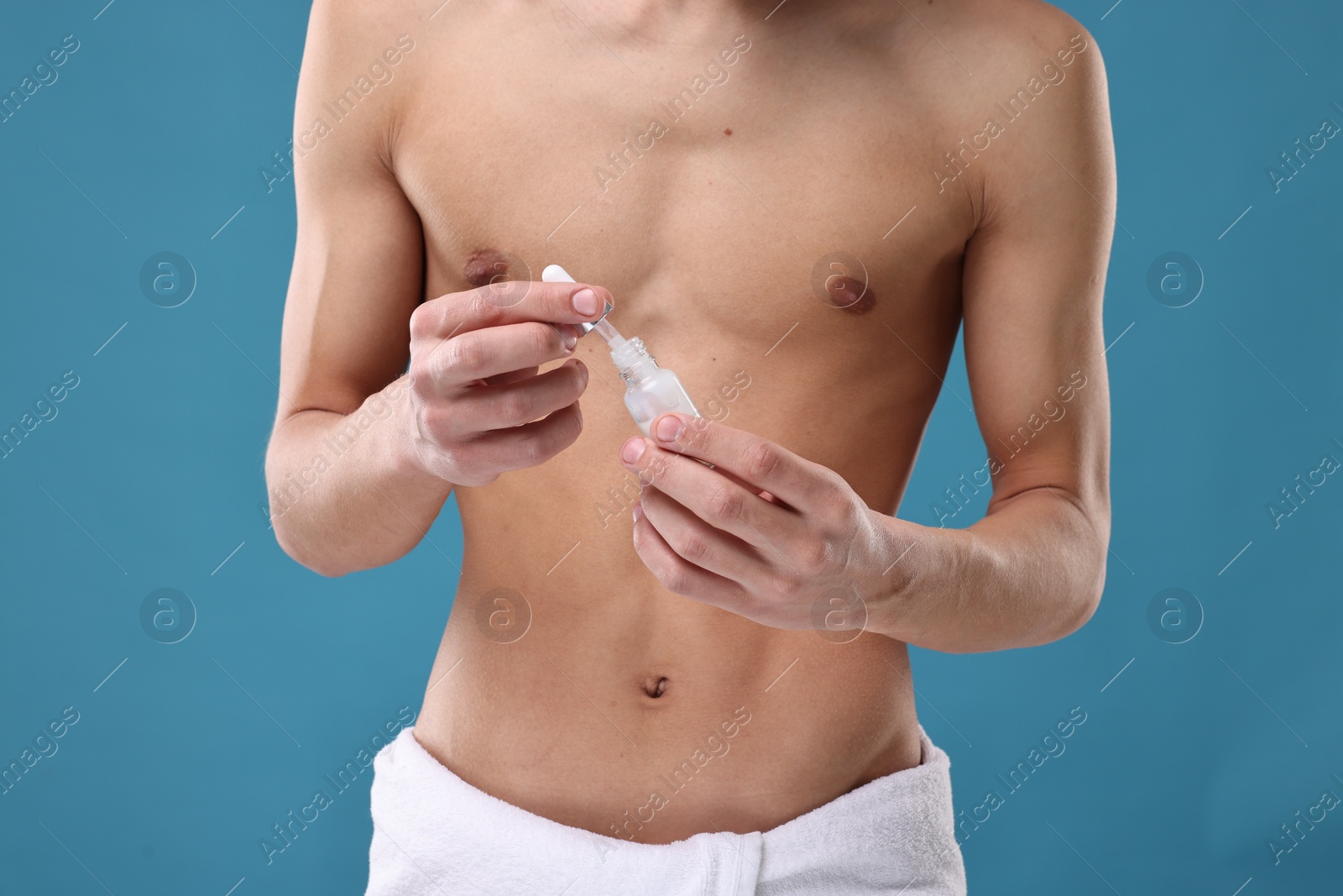 Photo of Man with serum on blue background, closeup