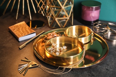 Photo of Composition with stylish accessories and interior elements on grey table