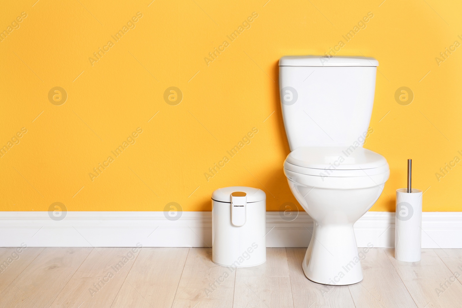 Photo of New ceramic toilet bowl in modern bathroom with space for text