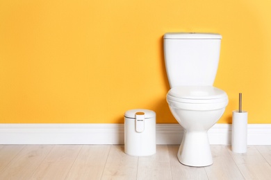 New ceramic toilet bowl in modern bathroom with space for text