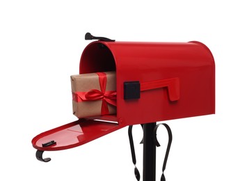 Red mailbox with Christmas gift isolated on white. Sending present by mail