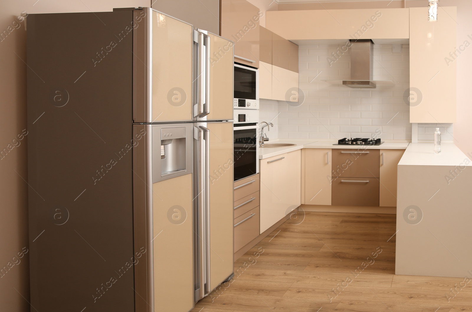 Photo of Interior of spacious modern kitchen with refrigerator