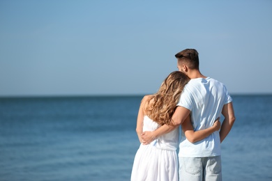 Photo of Happy young couple at beach on sunny day