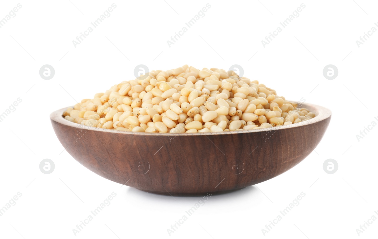 Photo of Plate with pine nuts on white background