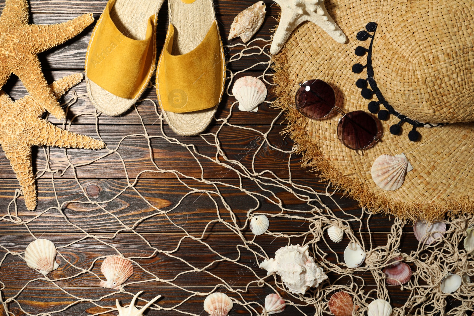 Photo of Flat lay composition with beach objects on wooden background