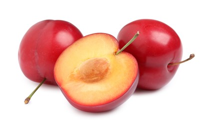 Photo of Cut and whole cherry plums on white background