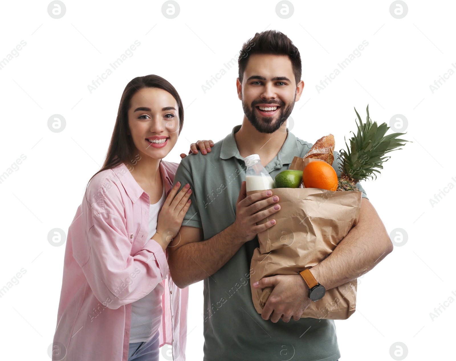 Photo of Young couple with groceries on white background