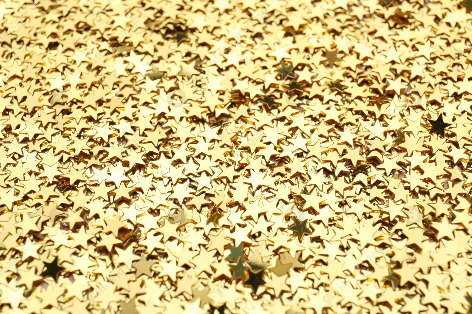 Photo of Confetti stars as background, closeup. Christmas celebration