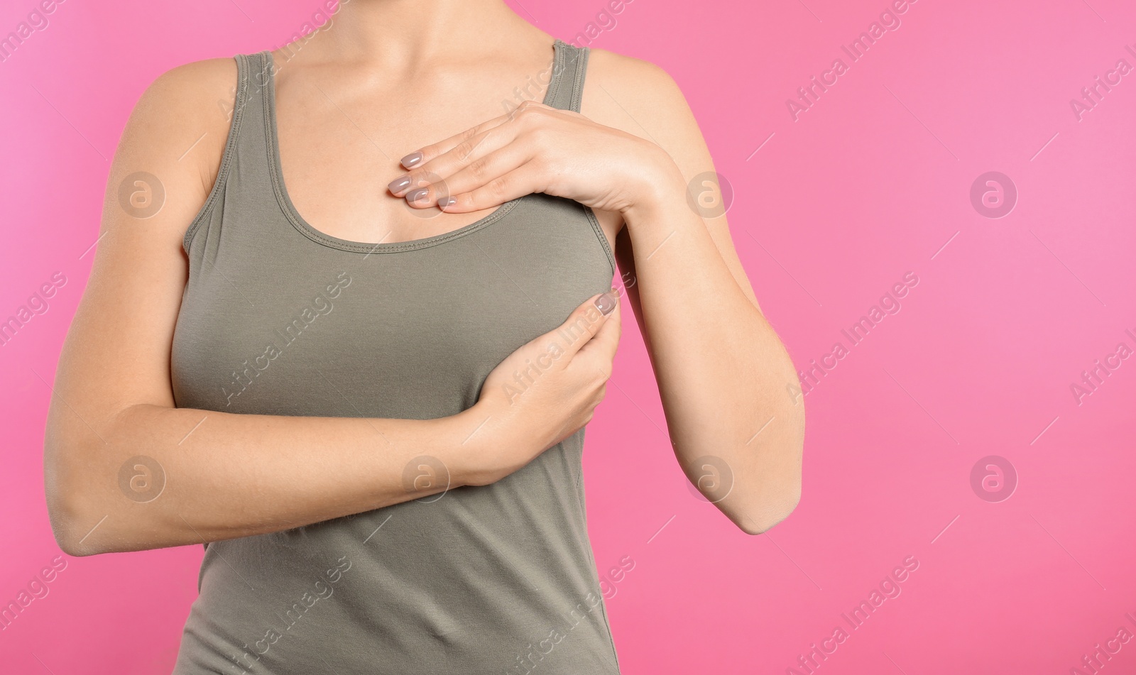 Photo of Woman checking her breast on color background, closeup. Space for text