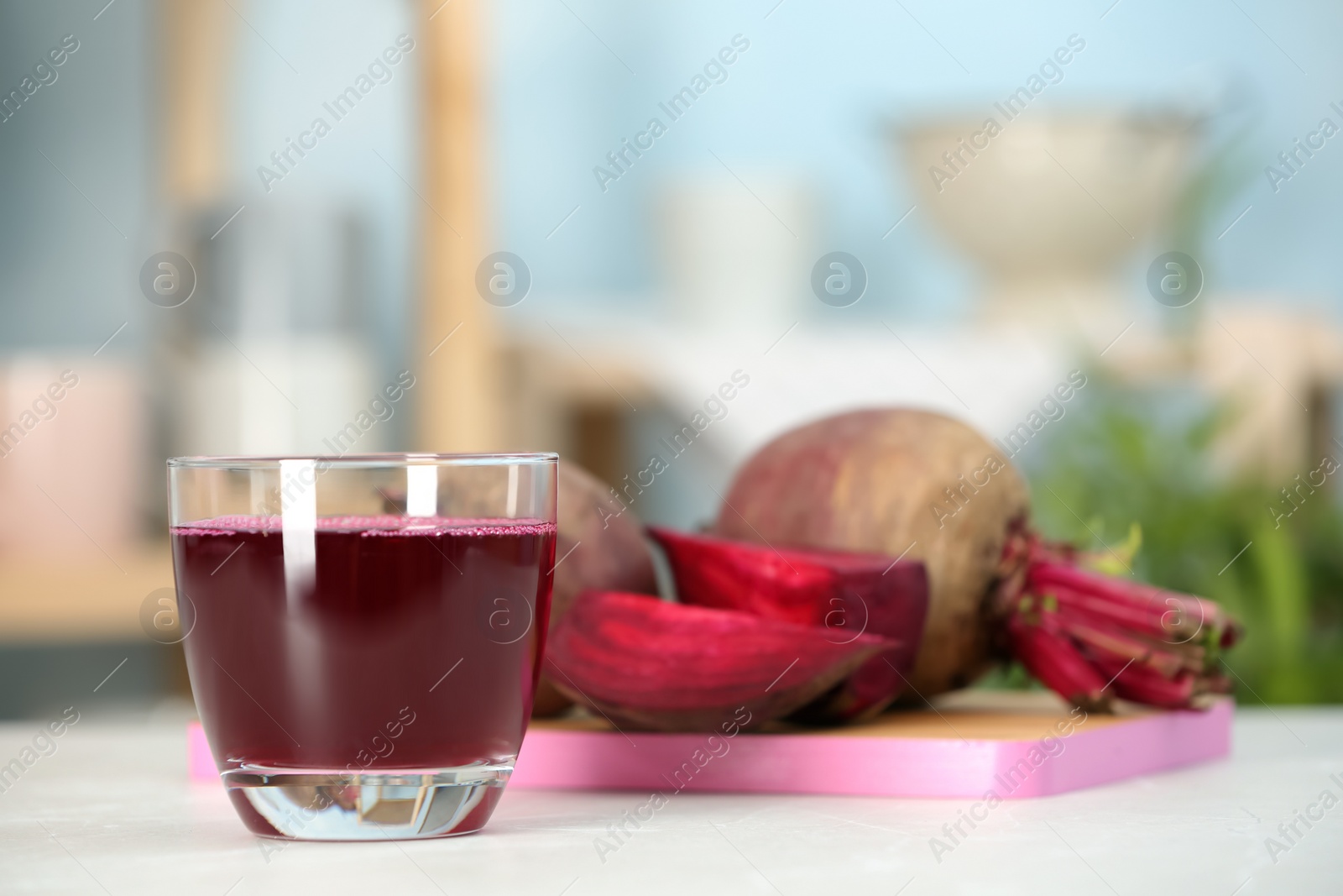 Photo of Glass with fresh healthy beet juice on table