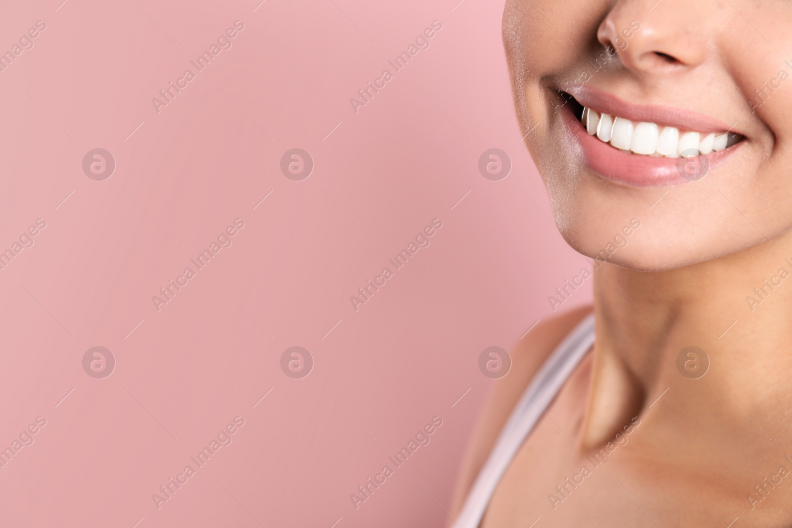 Photo of Young woman with healthy teeth on color background, closeup. Space for text