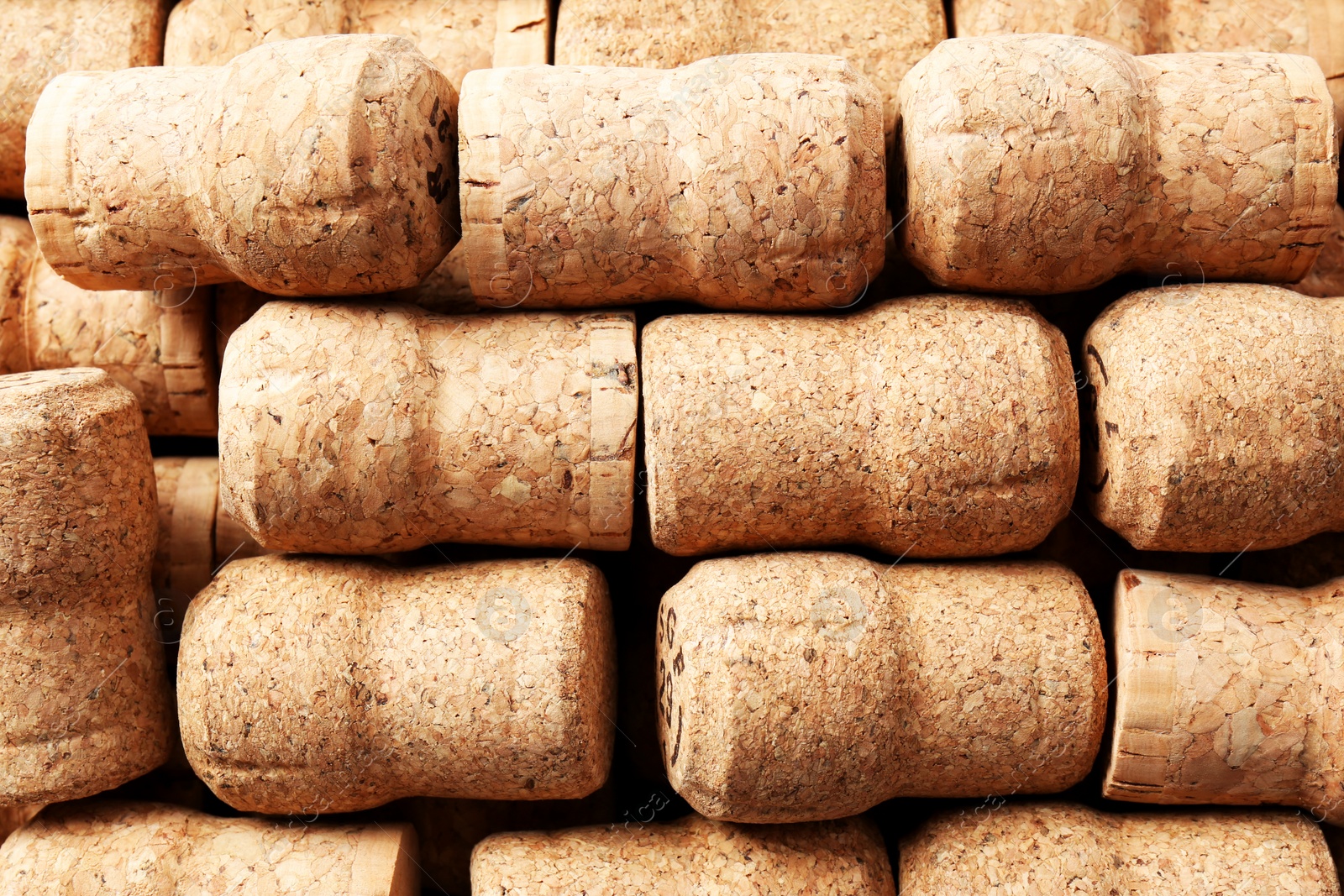 Photo of Many corks of wine bottles as background, top view