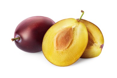 Photo of Whole and cut ripe plums on white background