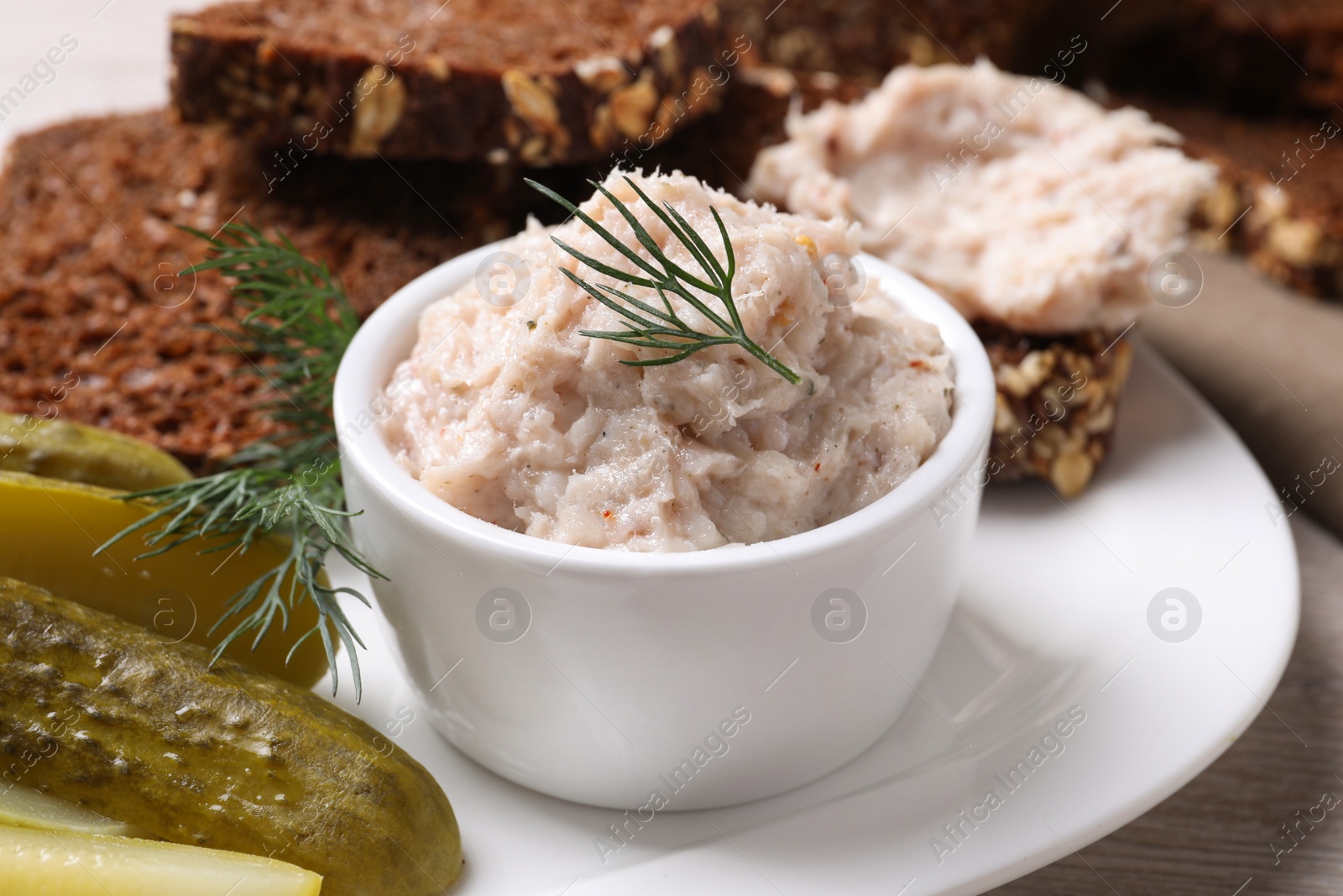 Photo of Delicious lard spread, bread and pickles on table, closeup