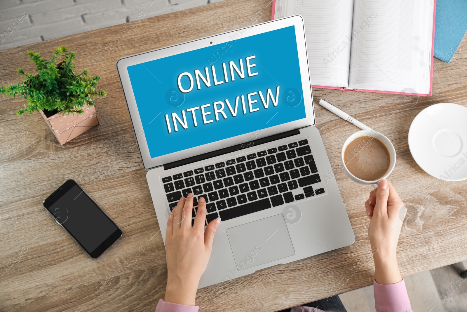 Image of Woman using laptop for online interview at table, top view 