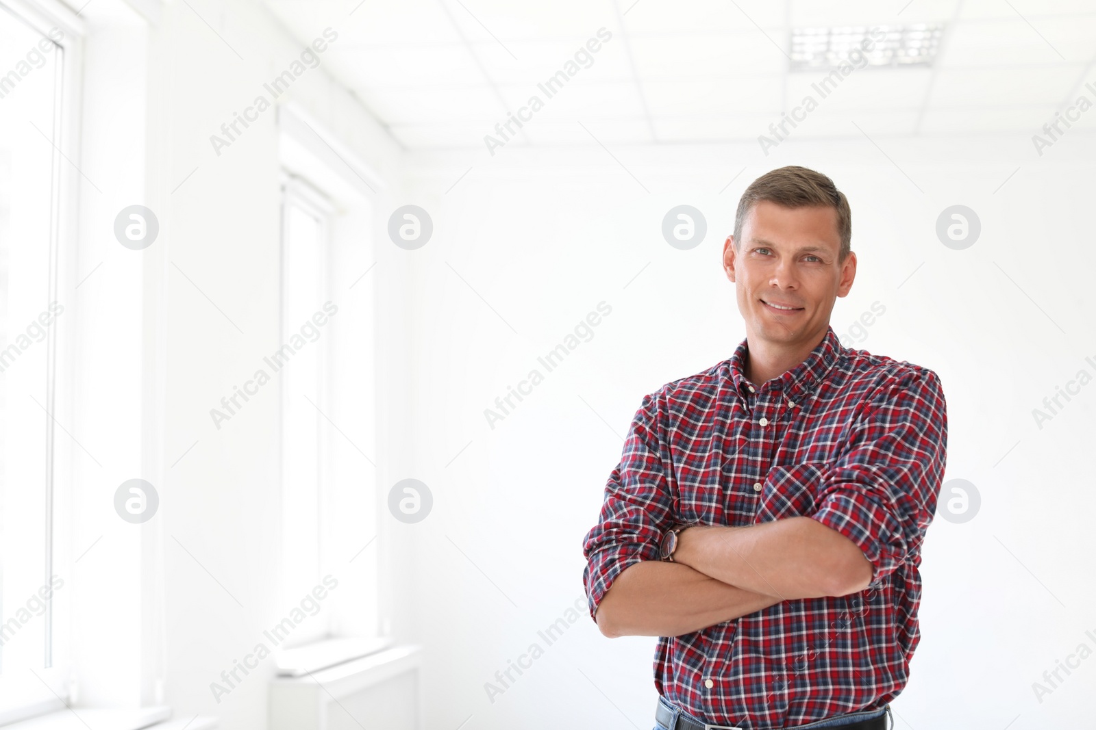 Photo of Young man standing in office room. Time to work