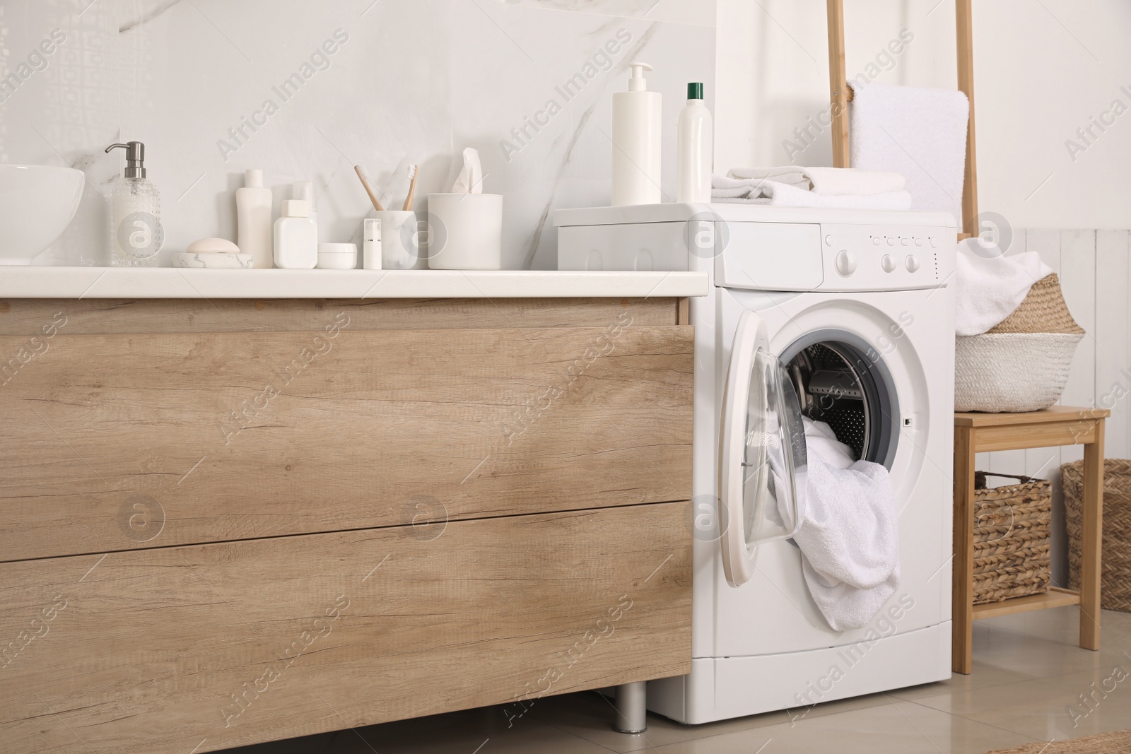 Photo of Stylish bathroom interior with modern washing machine