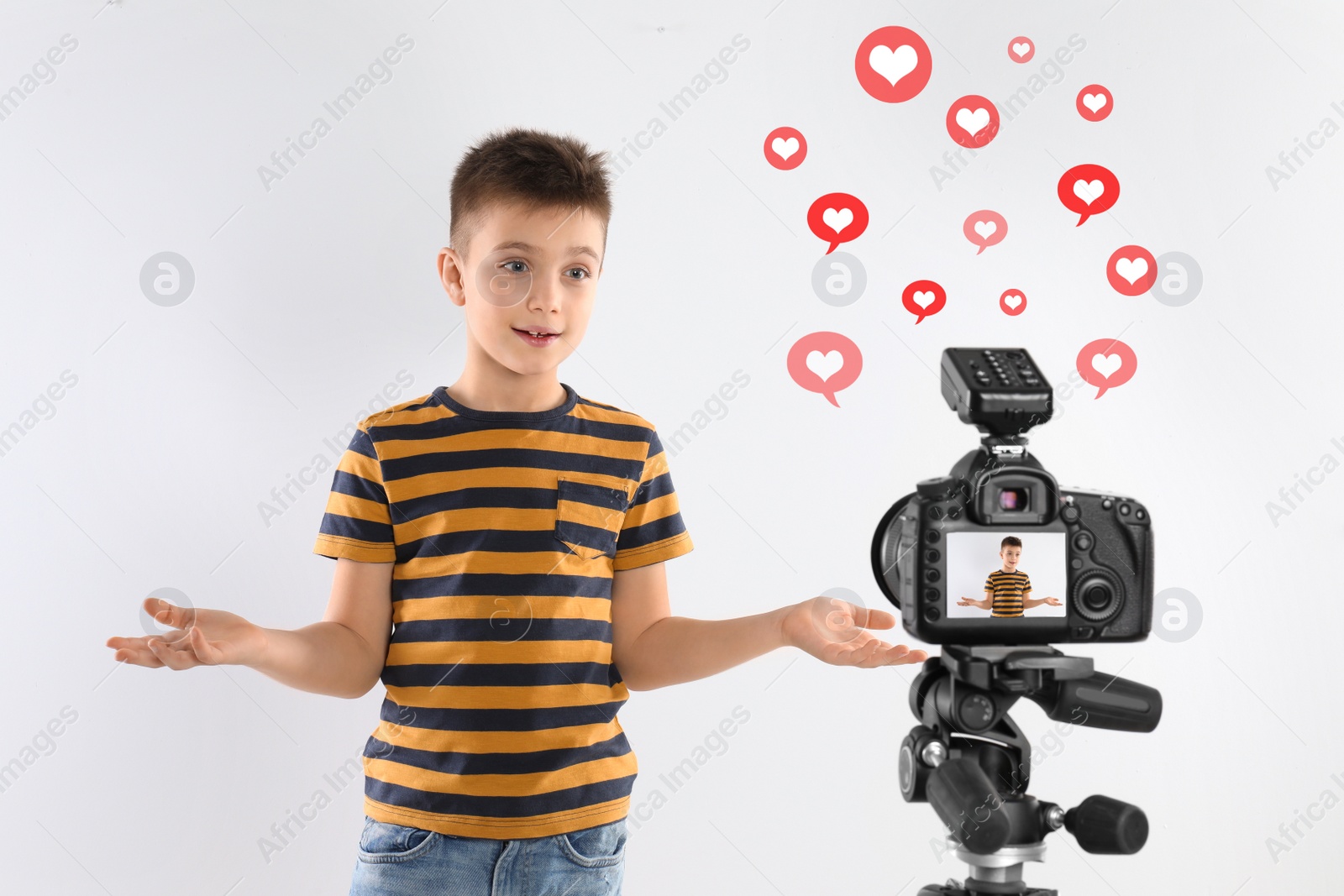 Image of Cute little blogger recording video on white background